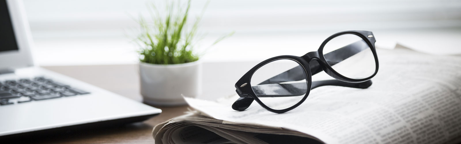 Glasses laying on newspaper